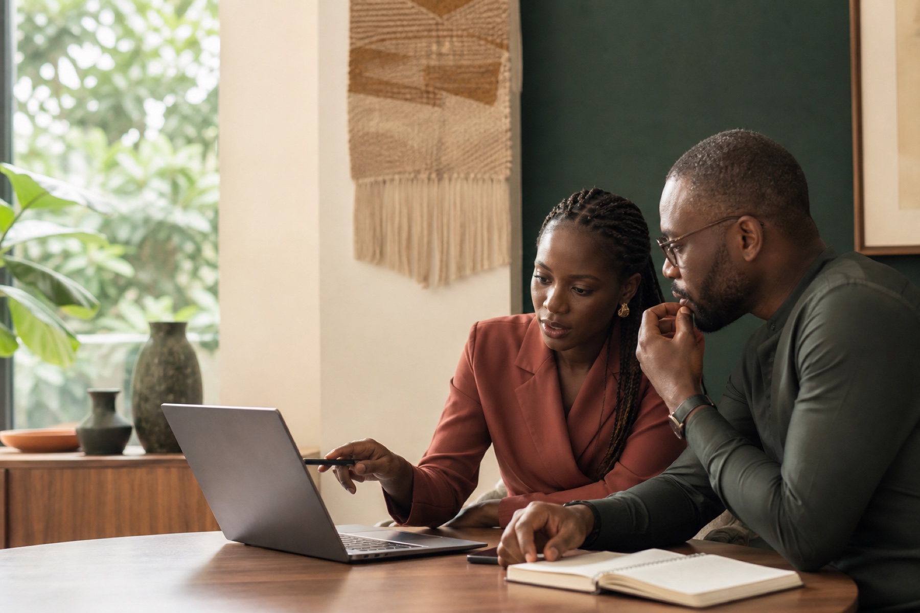 Two Nigerian professionals learning together in a Lagos workspace